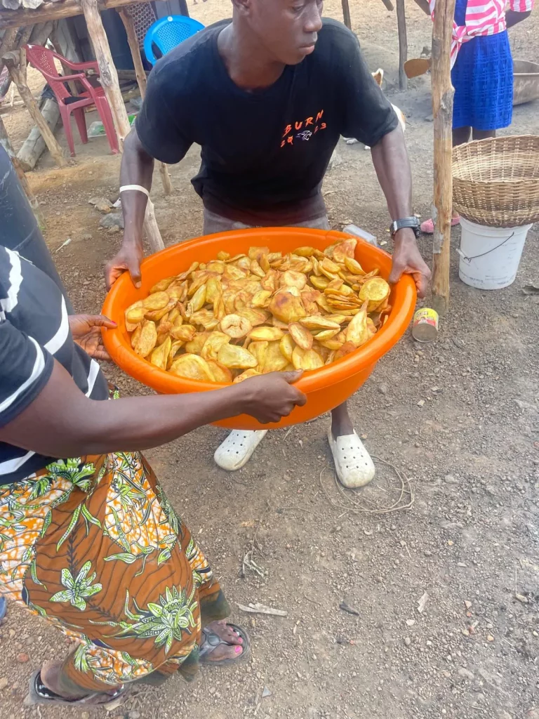 Photo from A Field of Firsts: EKMOI's Children Feed Gbongboma Village