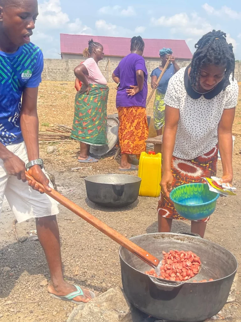 Photo from A Field of Firsts: EKMOI's Children Feed Gbongboma Village